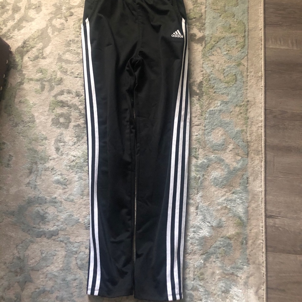 Black Adidas athletic pants with white Stripes